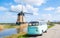 road trip with an old vintage car in the Dutch flower bulb region with tulip fields