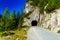 Road with tunnel mountain passage on summer day