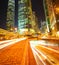 Road tunnels light trails on modern city buildings backgrounds i