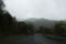 Road turn with a scenic nature landscape surronding on a rainy day