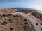 Road with turns  and following the car made by a drone on the seashore