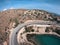 Road with turns made by a drone on the seashore with turquoise water and waves in Greece