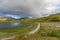 Road under Colorful Rainbow in Lofoten islands, Norway, selective focus