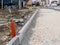 The road under construction in the city: the curbstone has already been laid, the gravel is poured and tamped, everything is ready