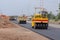 Road under construction, pneumatic tyred roller paver at asphalt