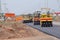 Road under construction, pneumatic tyred roller paver at asphalt