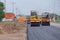 Road under construction, pneumatic tyred roller paver at asphalt