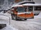 Road Vehicle Snowplow in action on Whitewashed Roads During a Snowy Day