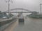 Road view of Golf II in Luanda city periphery, with rain,wet asphalt road vehicles and bridge as background