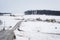 Road and view of snow covered farms and rolling hills, near Jeff