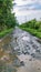 the road was flooded with rain, stones and mud