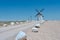 Road way decorated with white rocks lead to ancient windmill in Campto de Criptana medieval town, Ciudad Real, Spain.