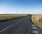 Road and wind turbines in rural landscape of northern France