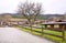 Road, wooden fence, wooden home lawn countryside in autumn