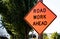 Road work ahead sign on a post