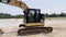 Road work heavy machinery earth mover road construction passing black car