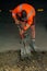 Road worker digging with shovel