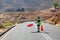 Road worker holds in hand red flag prohibiting traffic, travel restrictions, road repair, customs border transport control