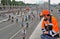 Road worker looks at Ñyclists riding on the road for cars