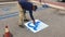 Road worker painting handicap signs