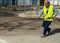 Road worker spraying bitumen emulsion