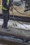 Road worker spraying manually bitumen emulsion 2