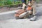 The road worker, using a petrol saw, cuts old asphalt
