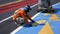 Road workers painting traffic road sign on asphalt road