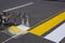 Road workers use hot-melt scribing machines to painting pedestrian crosswalk on asphalt road surface in the city