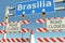 Roadblocks near Brasilia city traffic sign. Coronavirus disease quarantine or lockdown in Brazil conceptual 3D rendering