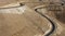 Roads going over a mountain of sand during daytime