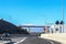 Roadside bathroom on Athens to Corinth Highway Greece  with snow-covered mountains of Peloponnese in the distance and a cloud of