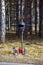 A roadside cross with a motorcycle helmet commemorating the tragic death of a motorcyclist.