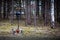 A roadside cross with a motorcycle helmet commemorating the tragic death of a motorcyclist.