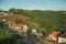 Roadside houses on a village with hilly forests