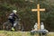 A roadside memorial cross with a candles commemorating the tragic death