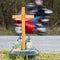 A roadside memorial cross with a candles commemorating the tragic death