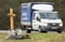 A roadside memorial cross with a candles commemorating the tragic death