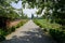 Roadside red-brick enclosure in countryside on sunny summer day