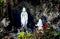 Roadside Religious Statues Virgin Mary with Flowers in Rock Cave