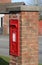 Roadside royal mail red postbox in brick column