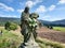 roadside shrine in the landscape of fields and forests in the sudetes mountains