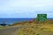 Roadside Signpost for Anakena beach, Ahu Tongariki, Hanga Roa town center and StopPARE sign against Pacific ocean, Easter Island