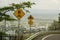 Roadside Signs On A Mountaintop With City Views In The Distance