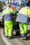 Roadside works. Men in overalls with shovels are cleaning the road and pouring rubble into the holes