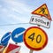 Roadsigns over cloudy blue sky. Men at work