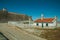 Roadway next to rustic house and dam wall