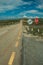 Roadway with STOP signpost on rocky landscape