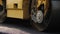 Roadway surface compressed by rotating drums of roller-compactor