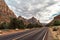 the roadway with a yellow line in between mountains and rocks